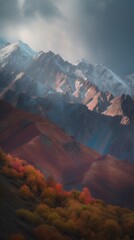 Stunning contrast between snowy mountain peaks and the warm hues of autumn trees