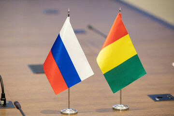 Flags of cooperation between Russia and Guinea. Flags of Guinea and Russia on the table....