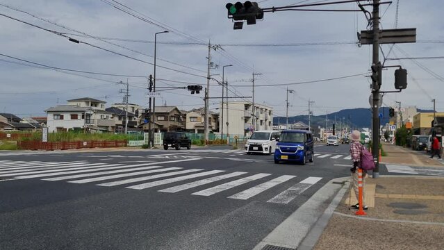 Nara, Japan on October 5, 2023. Traffic in front of Porsche Center Nara and Suzakumon Gate Heijo Palace Site Historical Park. Quite busy with cars, bus, trucks, heavy vehicles and container trucks. 