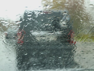 Fototapeta premium autumn road, raindrops on the car windshield, abstract background