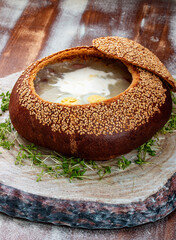 Zurek, sour soup made of rye flour with sausage and egg served in bread bowl. Popular Easter dish.