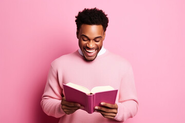 Cute African American young man toothy smile hold read opened book isolated on pink color background - Powered by Adobe