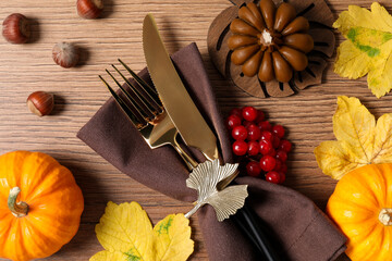 Thanksgiving table setting. Cutlery, napkin and autumn decor, flat lay
