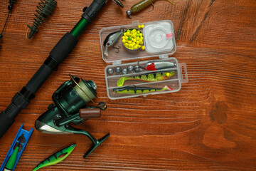 Fishing tackle on wooden table, flat lay. Space for text