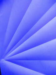 Abstract background, white-blue paper sheet folded in waves with light, shadow and copy space.