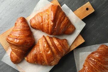 Delicious fresh croissants on grey table, flat lay