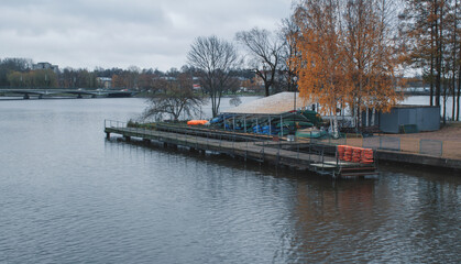 Autumn landscape with an empty river pier.
