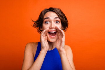 Photo of nice positive impressed lady arms near open mouth communicate shout isolated on orange color background