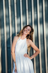 Fototapeta premium Beautiful woman for a walk in the park on the street near a wooden building