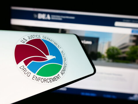 Stuttgart, Germany - 11-11-2023: Smartphone with seal of United States Drug Enforcement Administration (DEA) in front of website. Focus on center of phone display.