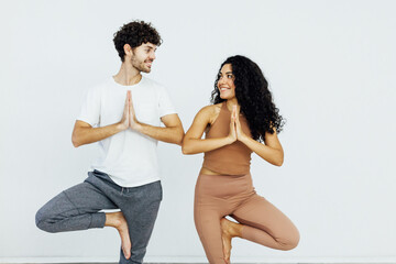 Man and woman doing yoga exercises meditation asana lotus pose