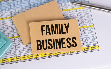 FAMILY BUSINESS text on notebook with chart and calculator