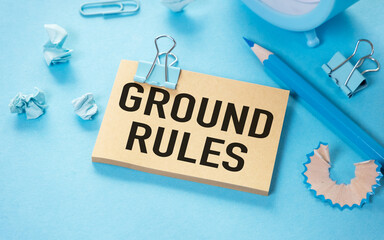 ground rule open notepad with text on a blue background multi- colored stationery.