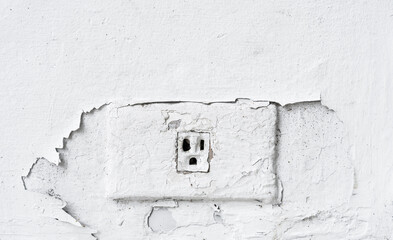 Old electric outlet on peeling wall background well space for text