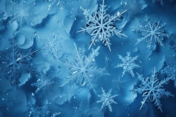  a bunch of snowflakes that are on a blue glass surface with drops of water on the surface and on top of the snowflakes are snowflakes.