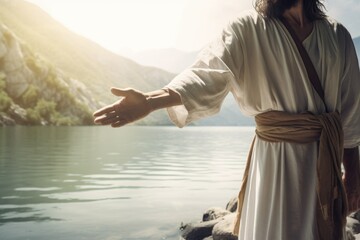 Jesus Christ near river reaching out his hand against bright background. Help for heart. Gospel, salvation, faith concept. Christian preach, sermon - obrazy, fototapety, plakaty