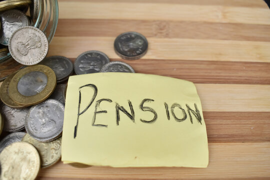 A closeup picture of Pension placed in front of coins