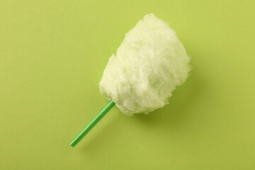Sweet cotton candy on green background, top view