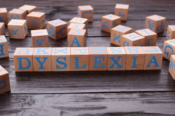 Cubes with word Dyslexia on wooden table - obrazy, fototapety, plakaty