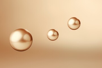  a set of three shiny balls on a beige background with a drop of water on the bottom of the image and a drop of water on the bottom of the image.