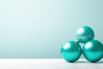  a group of three turquoise balls sitting on top of a white table next to a light green wall and a light blue wall in the middle of the room behind.