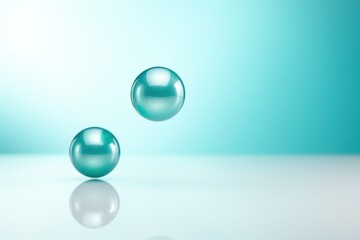  a couple of glass balls sitting on top of a white table next to a blue and light blue wall with a light reflection on the top of the glass surface.