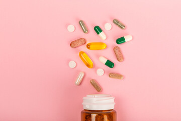 Vitamins and supplements. Variety of vitamin tablets in a jar on a texture background.Multivitamins...
