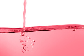 Red water surface with splashes and bubbles on white background.