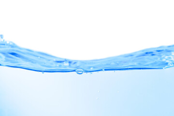 Blue water surface with splashes and bubbles on white background.