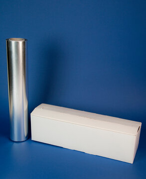 Aluminum foil roll with white box on blue background.