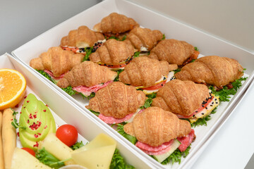 Set of sandwiches with croissants and sausage with greens