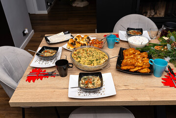 A table set before Christmas dinner with many traditional Polish dishes.