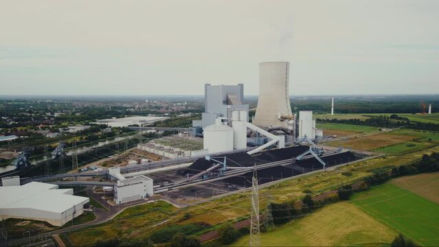Aerial view of power station in the countryside with a high chimney in Europe.