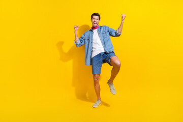 Full size photo of overjoyed guy wear jeans jacket shorts clenching fist s scream yes win bet...