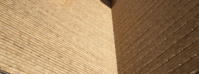 Panorama view of Sunlight and Shadow on a Yellow Brick Wall.