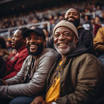 Multigenerational men of African descent enjoying a lively event at a stadium showcasing family bonding and happiness in a diverse crowd