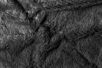 Black fur background texture. dark wool close up