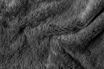 Black fur background texture. dark wool close up