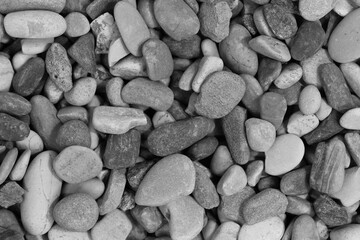Black sea pebbles background texture. dark aquarium soil. beach pebbles close up
