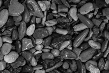 Black sea pebbles background texture. dark aquarium soil. beach pebbles close up