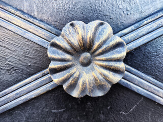 The fragment of forged metal products. close-up. Beautiful flower, handmade. Abstract background,...