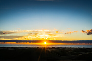 Sunrise over the Atlantic Ocean. Shot from the Dunes of Maspalomas Gran Canaria