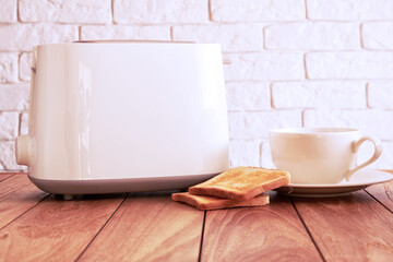 Wooden table with toaster, fresh bread and white coffee mug. Home kitchen backgrounds - obrazy, fototapety, plakaty