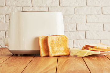 Electro toaster with baked bread and cheese on the white plate. Home kitchen backgrounds - obrazy, fototapety, plakaty