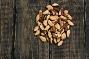 Peeled brazil nut on decorative wooden background