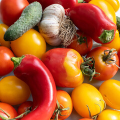 Fresh organic tomatoes and garlic, pepper, cucumbers, close-up image. Healthy vegan food.