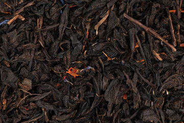 Pile leaf tea with various additives background, top view. Heap of dried tea texture