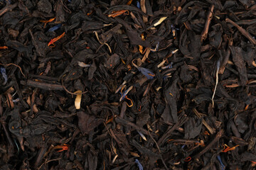Pile leaf tea with various additives background, top view. Heap of dried tea texture