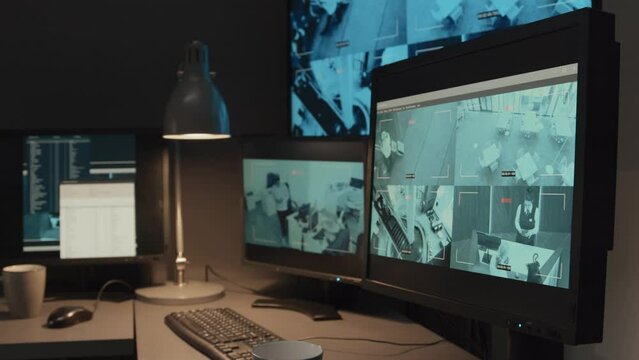 Arc no people shot of multiple monitors with surveillance CCTV video footage of public or private organisation in guard booth