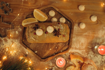 Christmas cake on wood stand with lemons